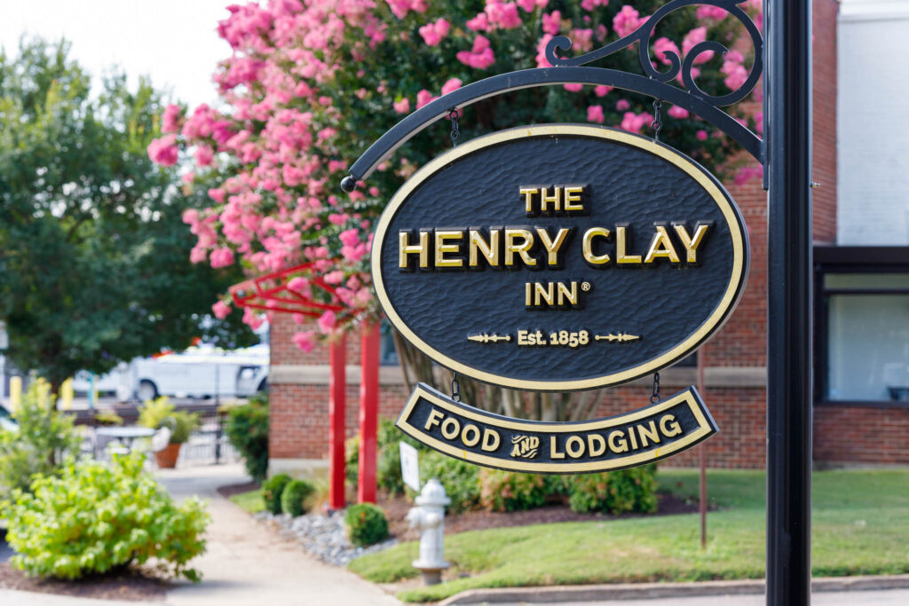 The Henry Clay Inn Sign with fresh blooming flowers - Est. 1858