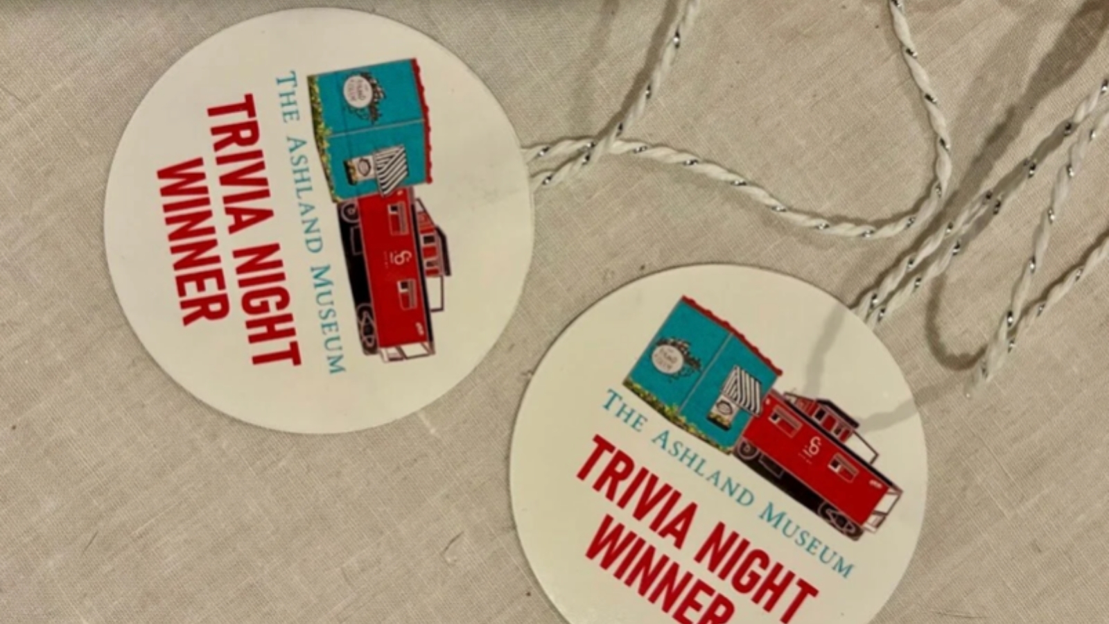 Ashland Museum Trivia Round badge reading 'Trivia Night Winner' with a red train illustration and 'The Ashland Museum' text.