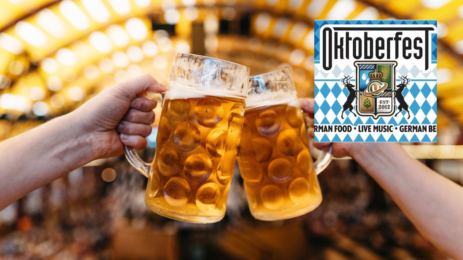 Two hands clink frosted beer steins in a festive Oktoberfest setting, with a blue-and-white Oktoberfest poster visible on the right.